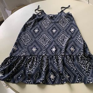 Blue and white dress with ruffle. Elastic a rose the back